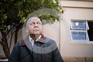 Retired senior man looking up