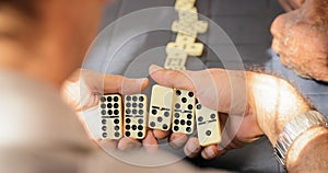 Retired Senior Man Playing Domino Game With Friends