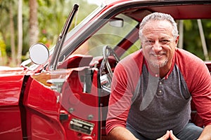 Retired Senior Man Sitting In Restored Classic Car