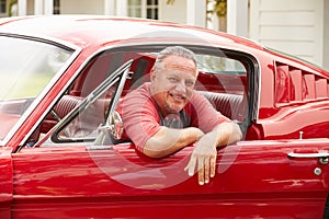 Retired Senior Man Sitting In Restored Classic Car