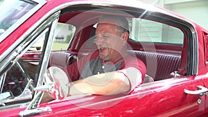 Retired Senior Man Starting Engine Of Restored Classic Car