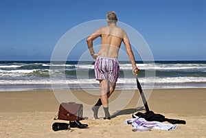 Retired senior man undressed on a caribbean beach, retirement freedom concept