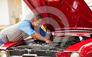 Retired Senior Man Working On Restored Car photo