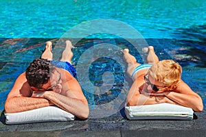 Retired seniors couple relaxing in swimming pool