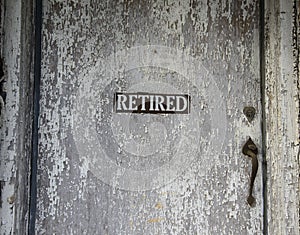 Retired Sign On Old Door