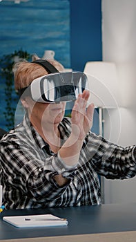 Retired woman experiencing virtual reality using vr headset at home