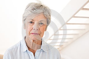 Retired woman frowning at the camera