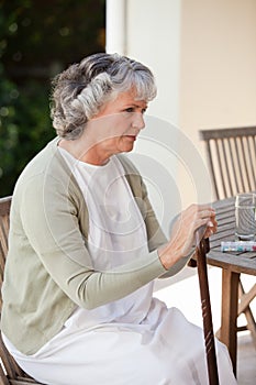 Retired woman with her walking stick