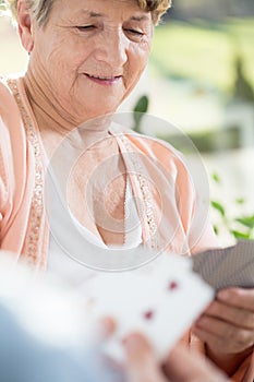 Retired woman playing cards