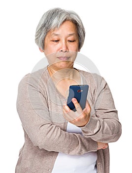 Retired woman read on cellphone