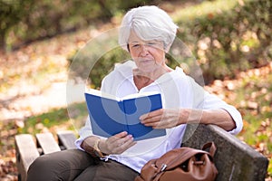 retired woman reading book