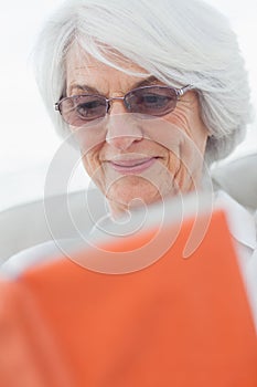 Retired woman reading a book