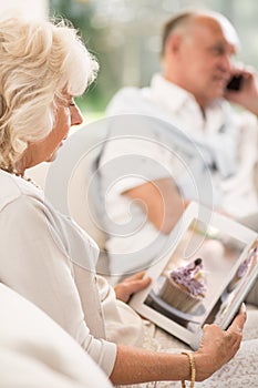 Retired woman reading book