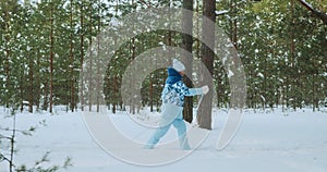 A retired woman rides classic skis in a winter forest.