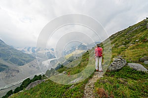 Retired woman During a walk in the high mountains