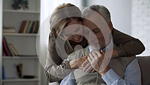 Retiree lady hugging man, loving relations in long marriage, closeness and care