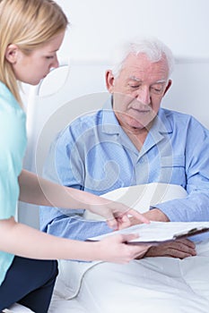 Retiree lying in hospital bed