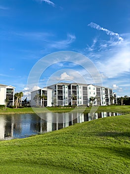 Retirement community condos on a resort golf course southwest Florida. Blue skies with water and lush green turf