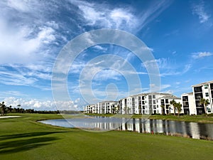 Retirement community condos on a resort golf course southwest Florida. Blue skies with water and lush green turf