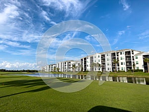 Retirement community condos on a resort golf course southwest Florida. Blue skies with water and lush green turf