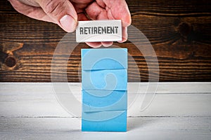 Retirement Concept. Colorful blocks in a pile on a painted wood texture background