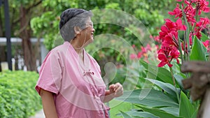 Retirement elderly old patient asian women use cane and walking in hospital outdoor park After rehabilitation and the illness has