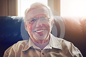 Retirement is here and I couldnt be happier. Cropped portrait of a happy senior man relaxing on the sofa at home.