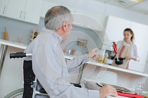 Retirement home with elder man on wheelchair