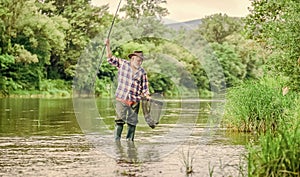 retirement. mature man fly fishing. man catching fish. fisherman with fishing rod. hobby and sport activity. pothunter