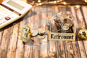 Retirement money jar savings motivational concept on wooden board