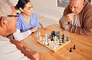 Retirement, playing and chess with senior men at nursing home for fun activity in home with nurse at table. Strategy
