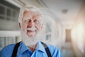 Retirement suits me like a glove. Portrait of a happy senior man posing in the hallway of his nursing home.