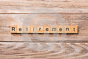 Retirement word written on wood block. retirement text on wooden table for your desing, concept