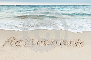 Retirement written on sand by sea photo