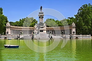 Retiro park lake in Madrid with fallen angel photo