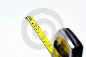 Retractable yellow metal measuring tape. Measurements expressed in centimeters and feet