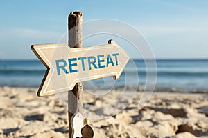 Retreat Arrow Sign On Beach