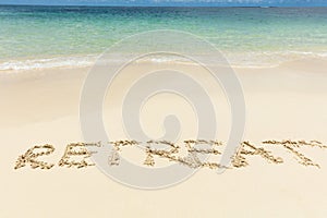 Retreat Text On Sand Near The Idyllic Sea At Beach