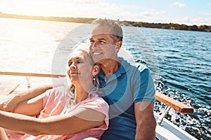 Retreating to the lake for a relaxing retirement. a mature couple enjoying a relaxing boat ride.