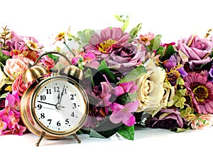 Retro alarm clock with flowers on white background