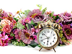 Retro alarm clock with flowers on white background