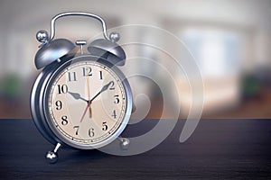 Retro alarm clock on bedside table in bedroom