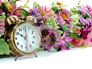 Retro alarm clock with flowers on white background