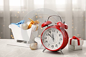 Retro alarm clock, gifts and festive decor on table