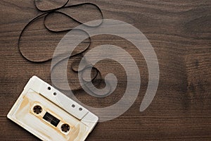 Retro audio cassette over wooden background