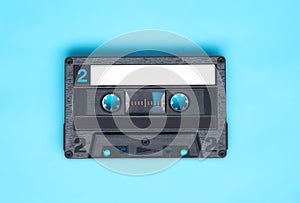 Retro audio cassette tape on turquoise background