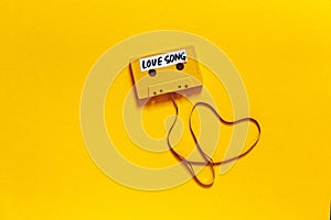 Retro Audio Tape With The Inscription Love Song On A Yellow Background, Top View. Romance Concept