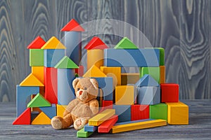 Retro Bear toy alone on wooden floor with bilding blocks