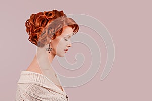 Retro beauty girl curly up hairdo style posing in studio in side profile