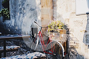 Retro bicycle with basket and flowers in a European city